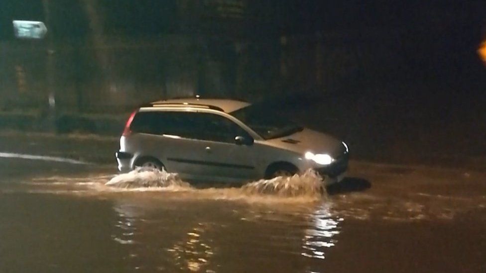 Car driving in a flooded street