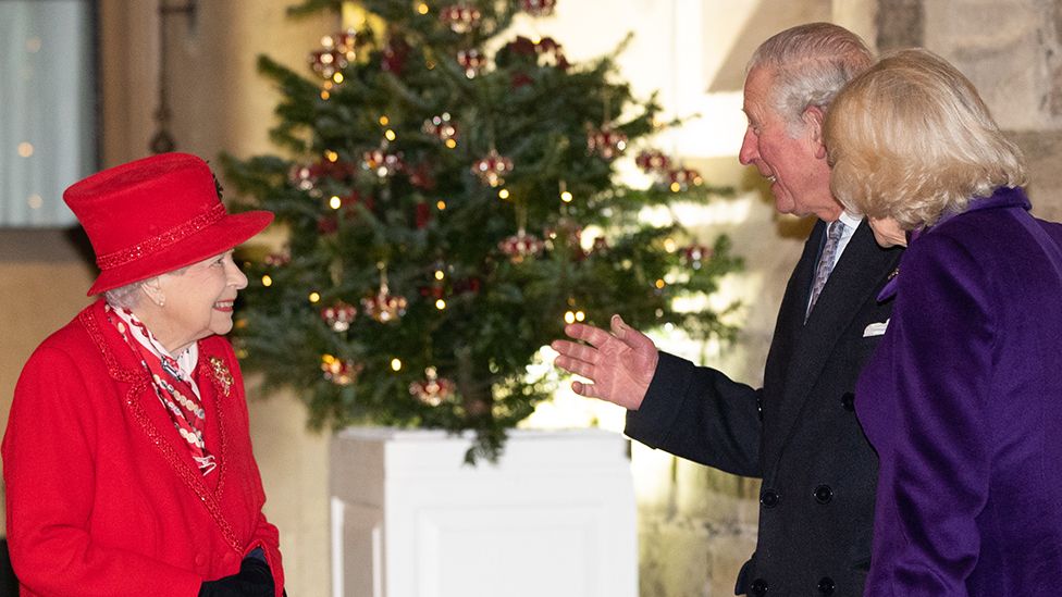 Queen Elizabeth II (L) talks with Prince Charles, Prince of Wales (C) and Camilla, Duchess of Cornwall as they wait to thank local volunteers and key workers for the work they are doing during the coronavirus pandemic and over Christmas in the quadrangle of Windsor Castle on 8 December 2020 in Windsor, England.