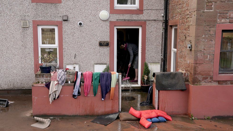 A man cleaning up after his house was flooded