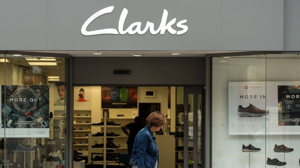 A woman passing a Clarks shop
