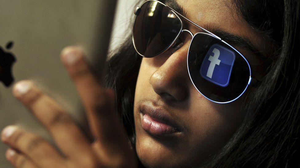 Indian girl with Facebook logo in sunglasses