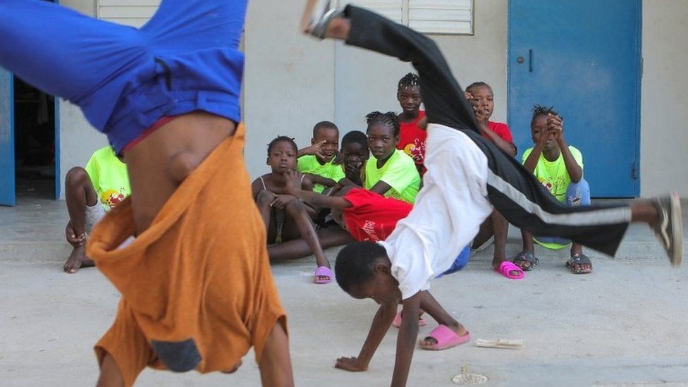 Haitian children who escaped violence in the town of Cite-Soleil play while they take refuge at a school
