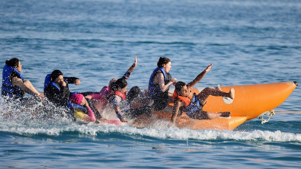 People riding on a banana boat on 23 July 2023