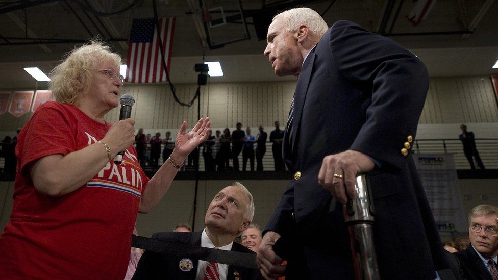 US Republican presidential candidate Senator John McCain (R) takes a question from a supporter (L), who called US Democratic presidential candidate Barack Obama an Arab, during a town hall meeting in Lakeville, Minnesota, October 10, 2008.