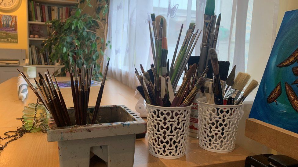 Pots with paint brushes