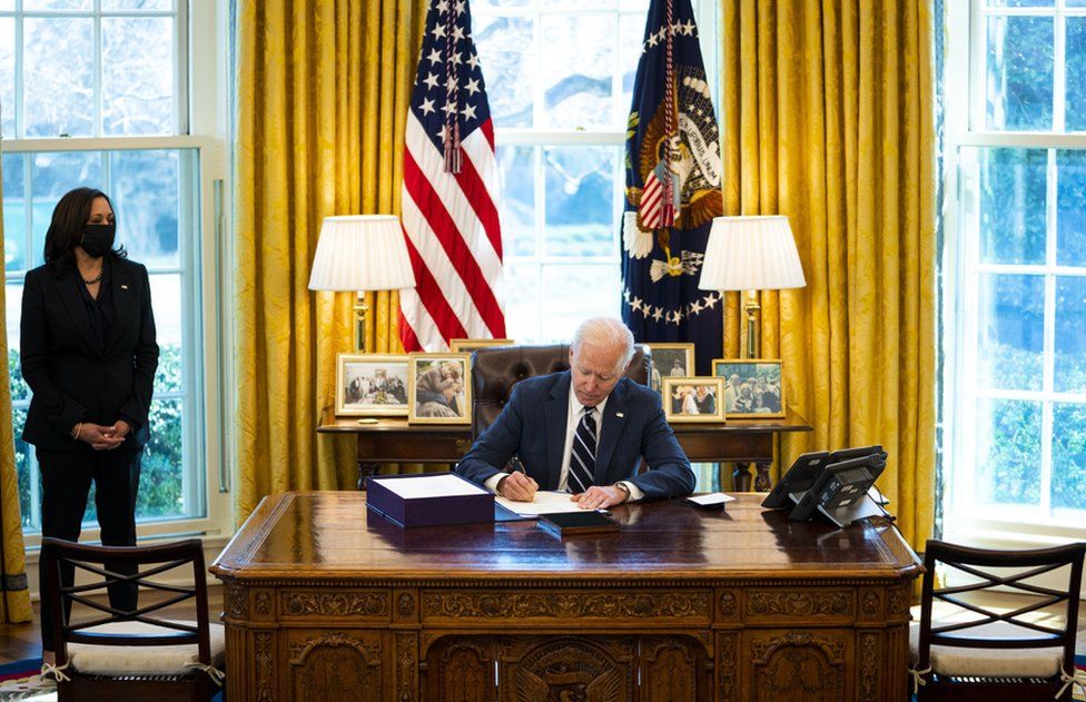 US President Joe Biden signs the American Rescue Plan with Vice President Kamala Harris looking on, in the Oval Office, in the White House, Washington, DC, USA, 11 March 2021.