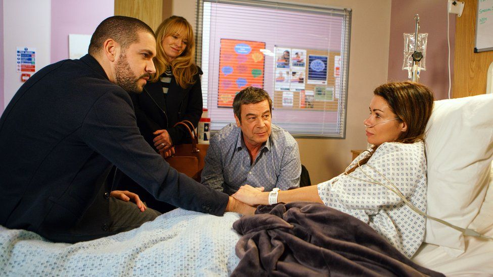 Carla Connor, played by Alison King, in hospital with Coronation Street cast
