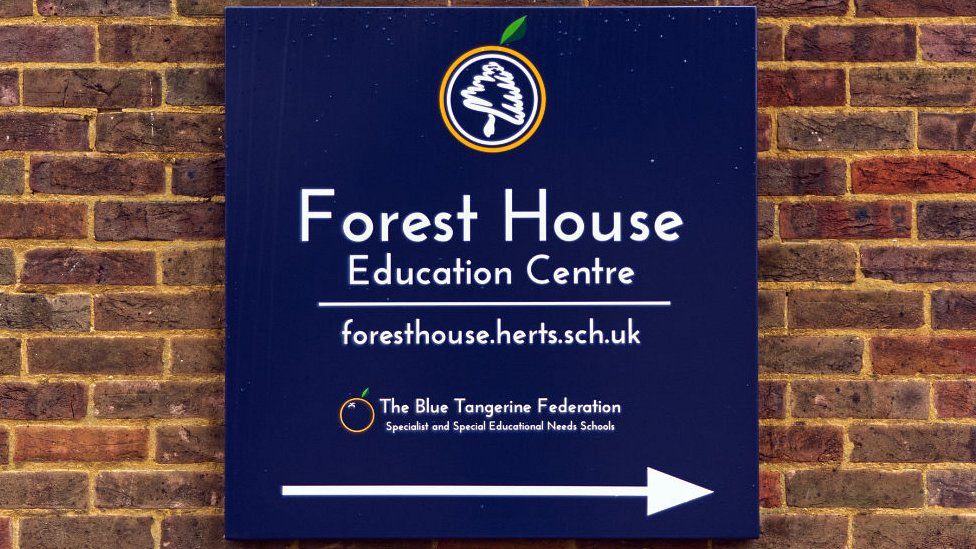 Forest House Education Centre sign against a brick wall