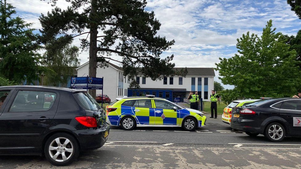 Police vehicles and officers at Tewkesbury School