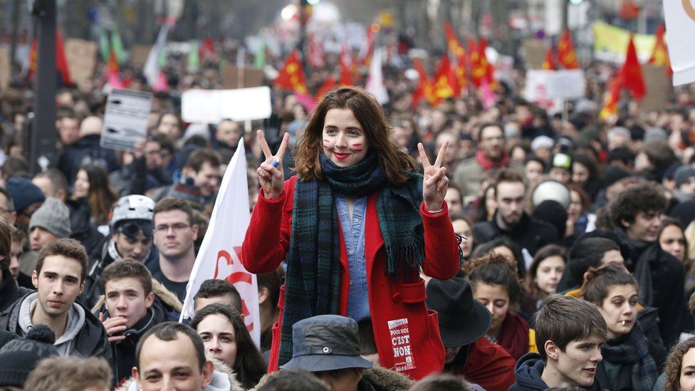 A woman flashes the V-sign as she takes part in a demonstration on 9 March 2016 in Paris, during a nationwide day of protest against proposed labour reforms