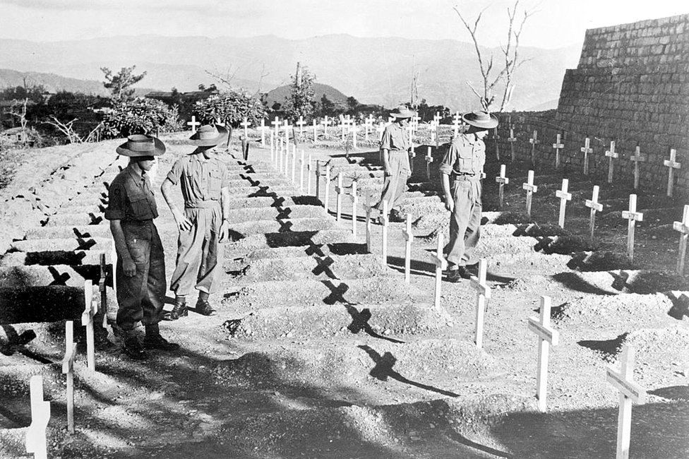 Men of the Royal West Kent Regiment pay silent tribute to comrades who fell in the Battle for Kohima, 27 November 1945