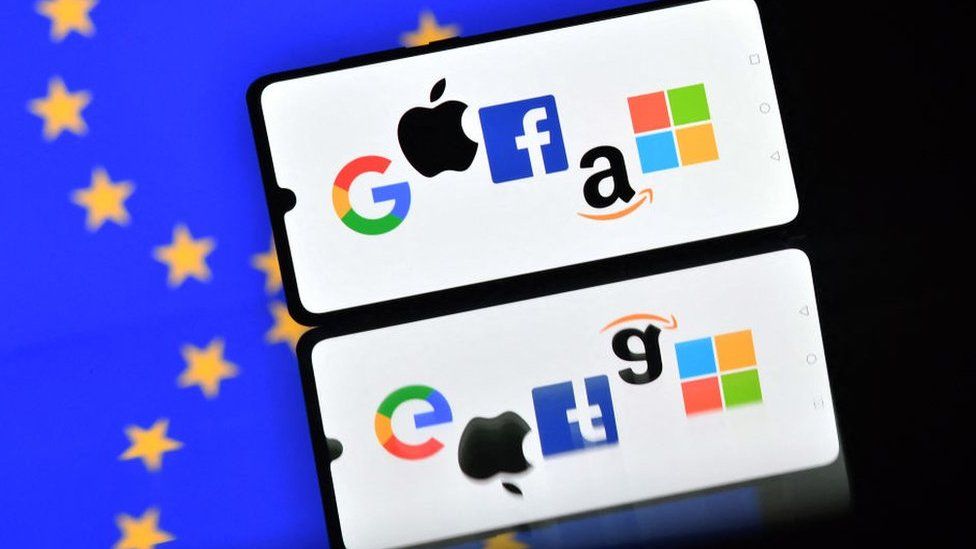 Smartphone displays Google, Apple, Facebook, Amazon and Microsoft logos against EU flag background