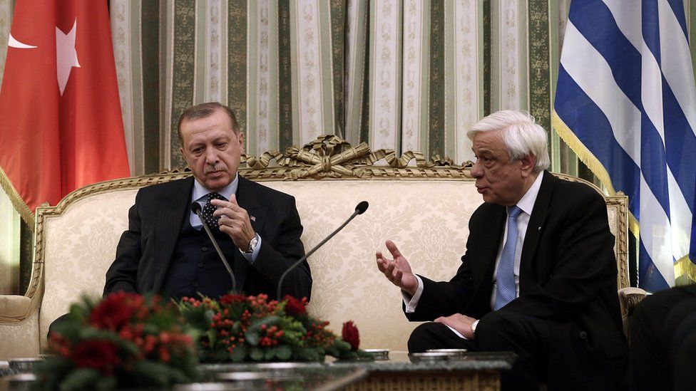 Greek President Prokopis Pavlopoulos talks with his Turkish counterpart Recep Tayyip Erdogan during a meeting at the Presidential Mansion in Athens