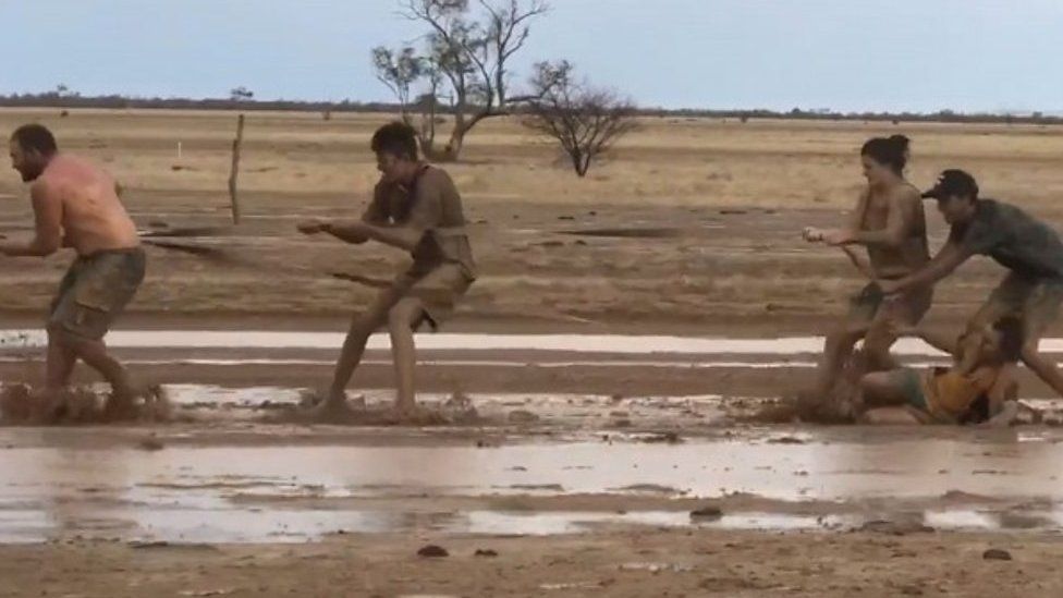 Australians play in mud