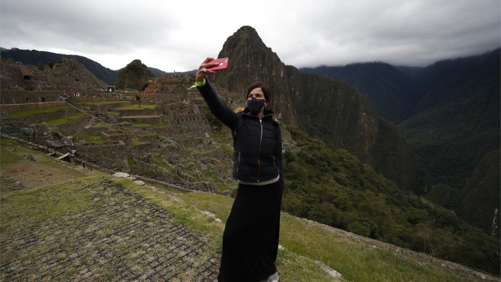 A tourist takes a selfie at Machu Picchu
