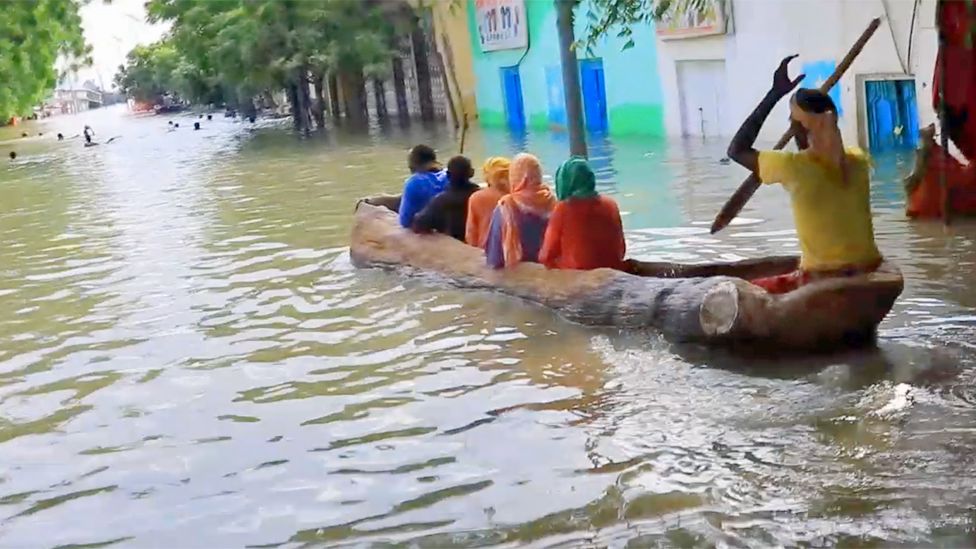 People using a boat to travel through Bardere, Somalia