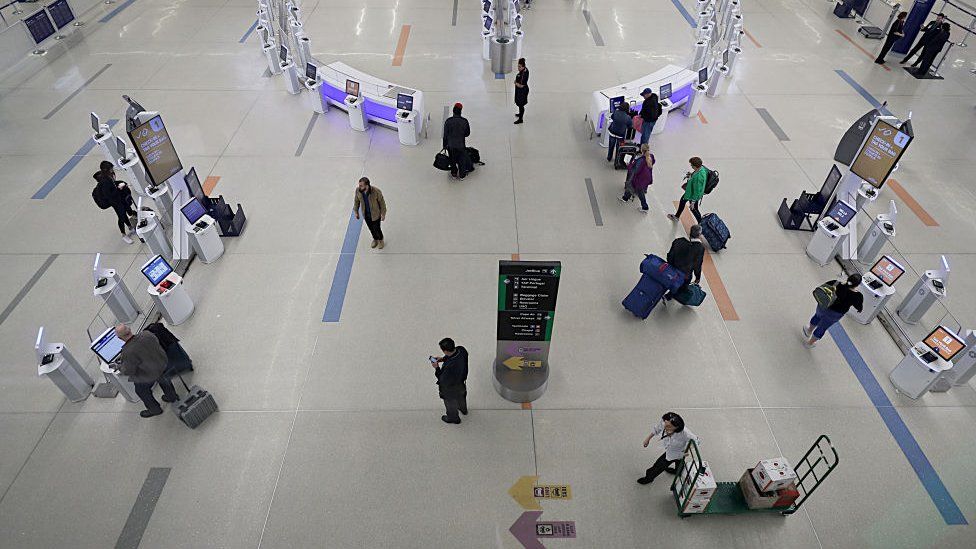 Travellers pass through the B terminal check-in concourse at Boston Logan International Airport on 2 April 2020