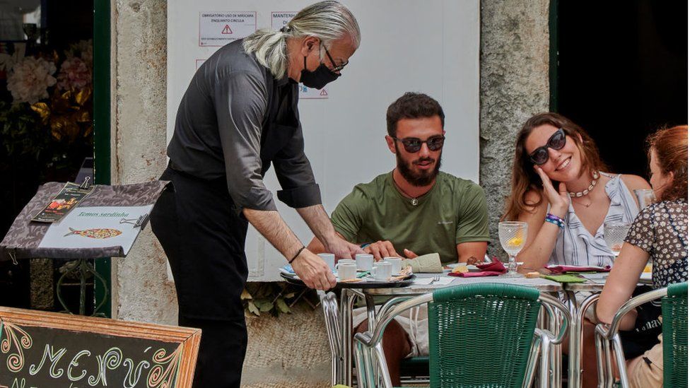 A man serves coffee in Lisbon, Portugal