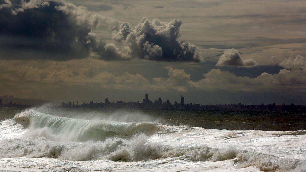Waves hit the port of Byblos, with the Lebanese capital Beirut in the background (22 February 2016)