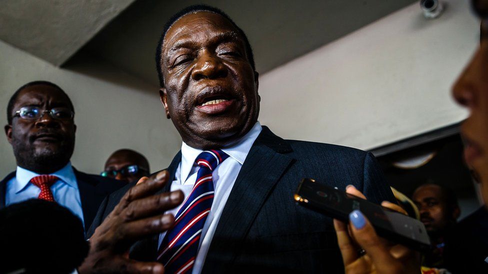 Zimbabwe's President Emmerson Mnangagwa speaks to the press after addressing mourners including family and opposition party supporters at the home of late opposition leader Morgan Tsvangirai,