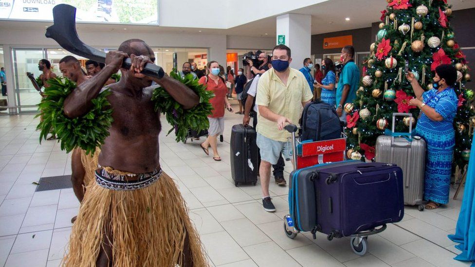 International arrivals at Fiji's main airport are welcomed by traditional dancers in December 2021