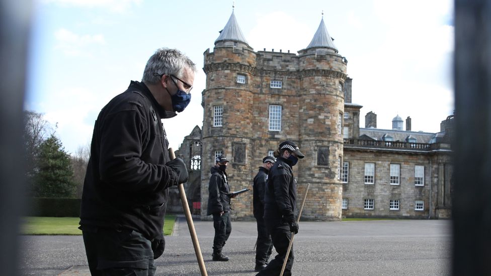 Police searching the palace grounds on Wednesday