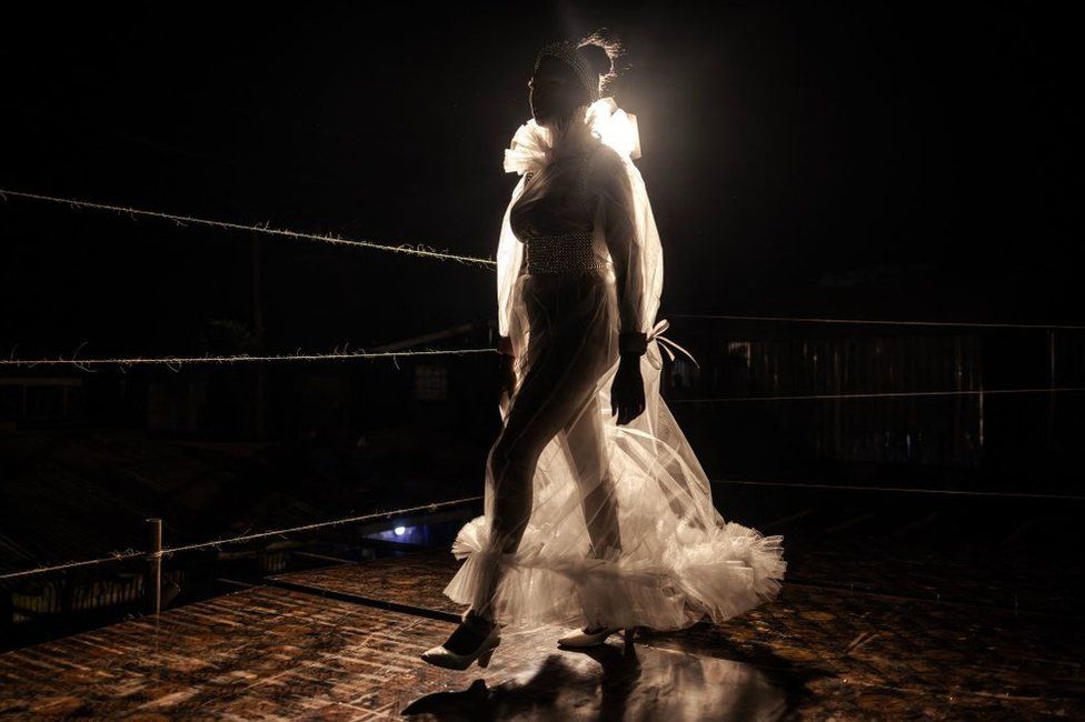 A models walks the catwalk while showcasing a design at the main fashion show during the Kibera Fashion Week in the informal settlement of Kibera in Nairobi, on October 15, 2023. Kibera Fashion Week is a platform created from the community to redefine fashion and creativity while showcasing beauty and talent as a way to change the narrative about Nairobi's largest informal settlement.