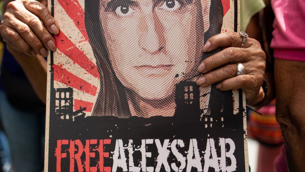 A demonstrator holds a poster that reads "Free Alex Saab" during a rally in support of Colombian businessman and close ally of Venezuelan President Nicolas Maduro in the Petare neighbourhood of Caracas, Venezuela, on Monday, April 4, 2022.