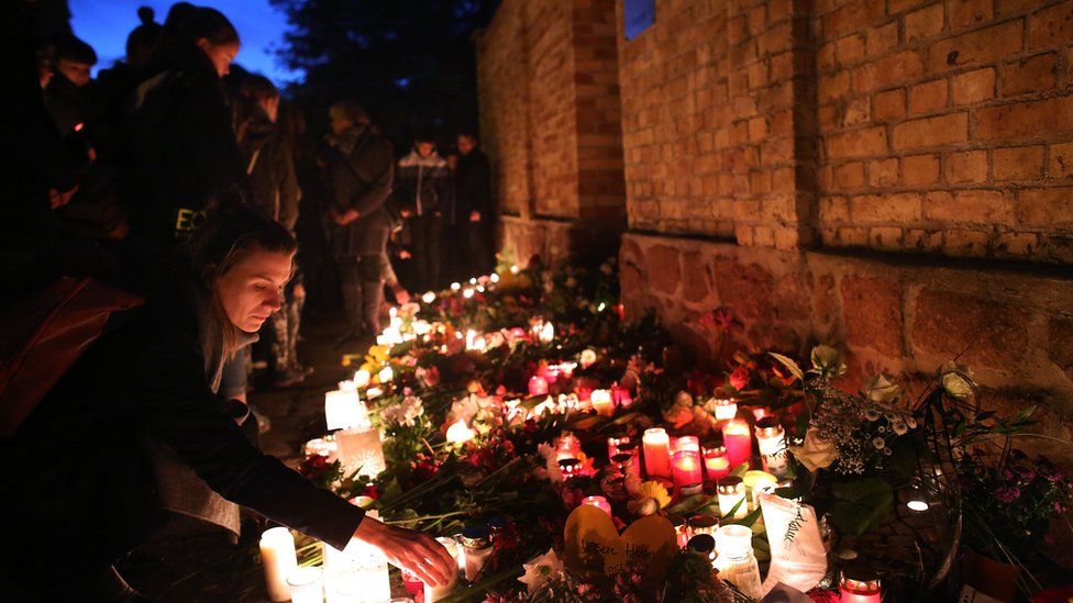 Mourners light candles at the synagogue in Halle and der Saale, eastern Germany, on October 10, 2019 one day after the deadly anti-Semitic shooting.