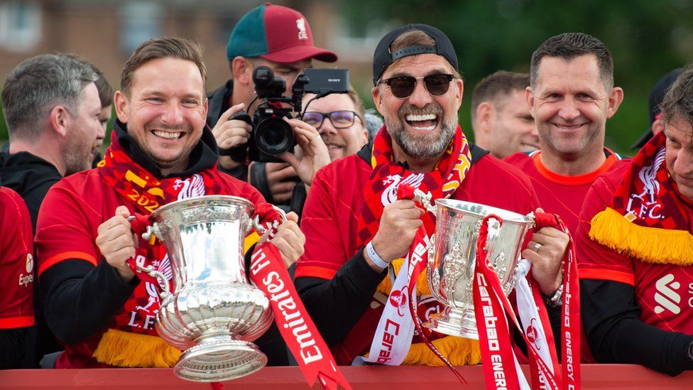 Liverpool manager Juergen Klopp reacts to fans during an open bus parade