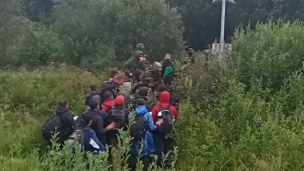 A video showing migrants trying to enter Lithuanian territory as border guards push them back