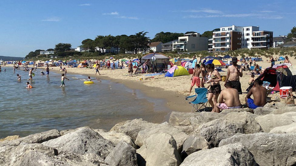 Families soaked up the sun on Sandbanks beach in Poole, Dorset