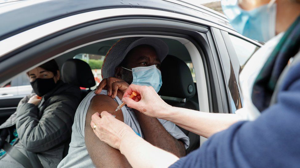 A man receives a COVID-19 vaccine at a drive-thru vaccination centre in St Albans