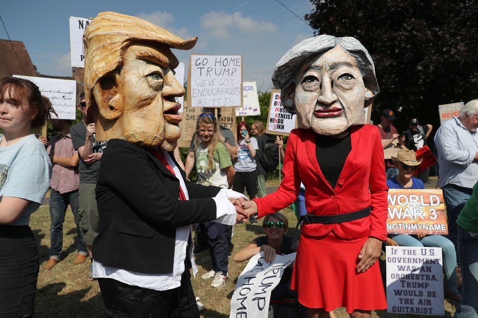 Demonstrators wearing Donald Trump and Theresa May paper mache heads join the protest in Butler's Cross, close to Chequers