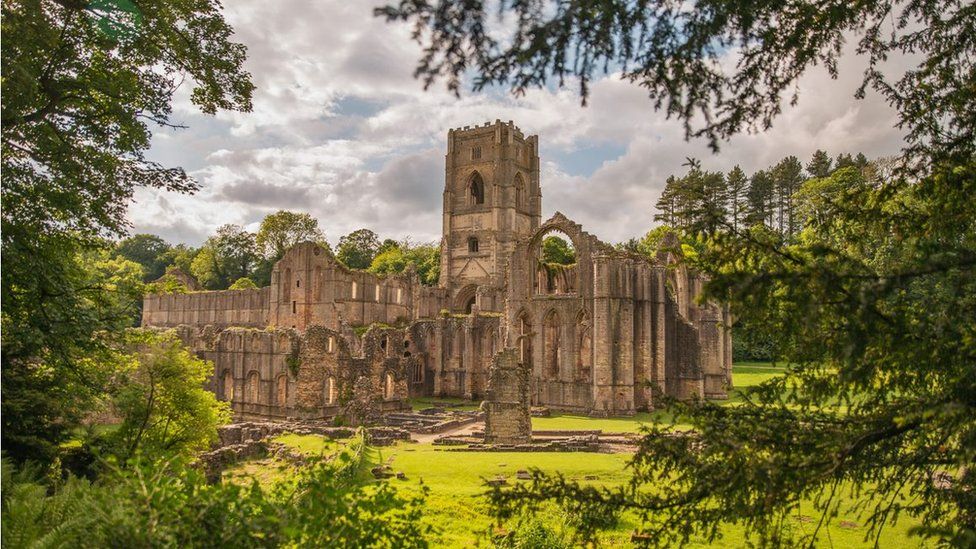 Fountains Abbey surrounded by greenery