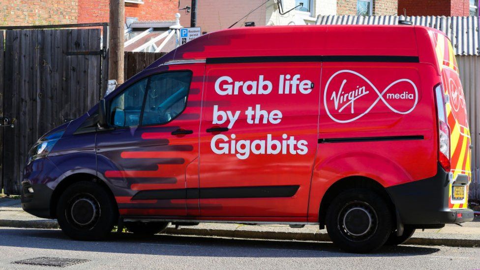 A Virgin Media van seen parked in London, emblazoned with the company logo and the slogan "grab life by the gigabits"