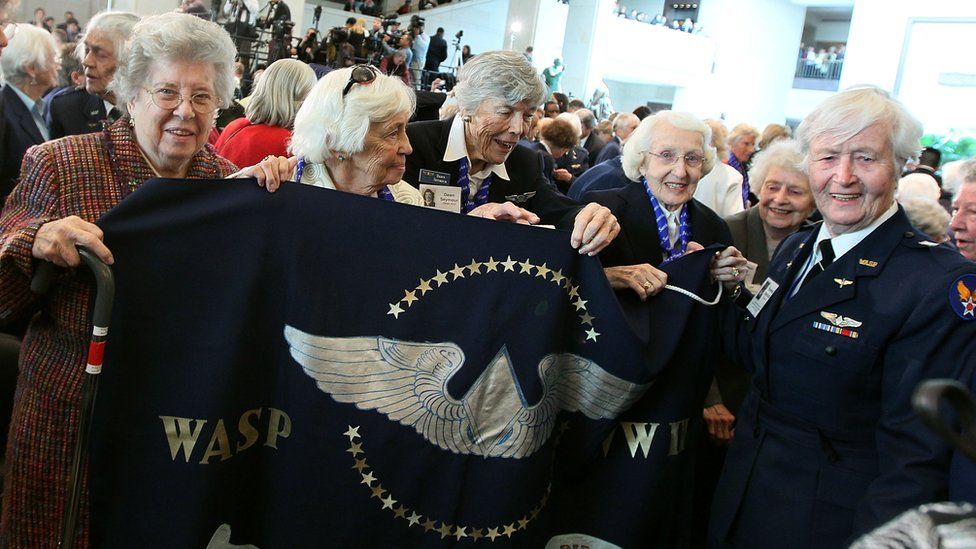 Former WASP pilots hold a banner during a Congressional Gold Medal ceremony at the US Capitol on March 10, 2010 in Washington, DC. The ceremony was held to honour the Women Air Force Service Pilots (WASP) of WWII. The WASP was a pioneering organization of civilian female pilots employed to fly military aircrafts under the direction of the United States Army Air Forces during World War II