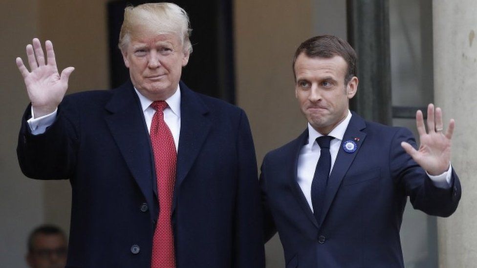 Donald Trump and Emmanuel Macron wave for the cameras outside the Élysée Palace in Paris on 10 November 2018.