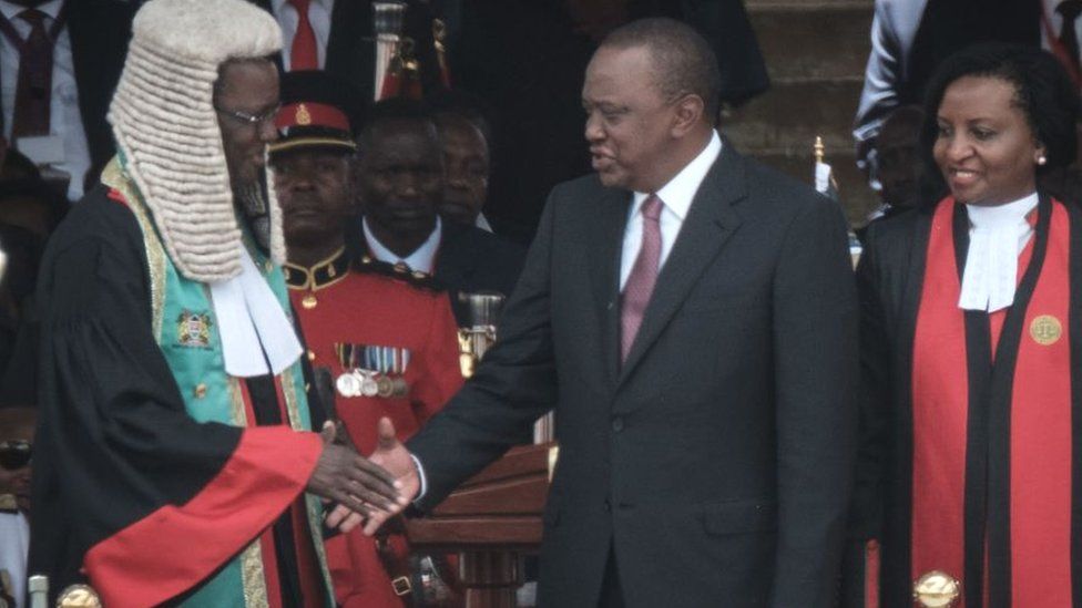 Kenya's President Uhuru Kenyatta (C) shakes hands with Kenyan Chief Justice David Maraga (L) after taking oath of office during the inauguration ceremony at Kasarani Stadium in Nairobi, Kenya - 28 November 2017