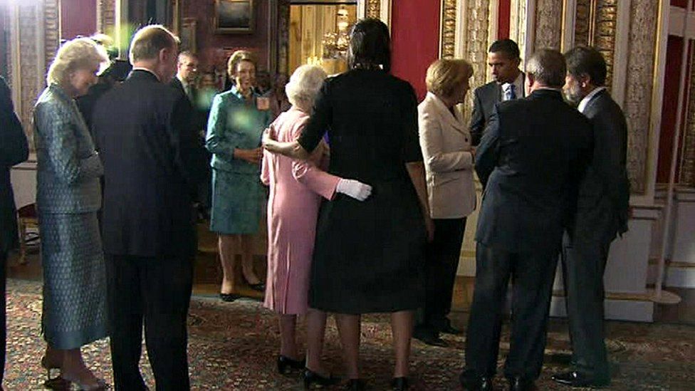 The Queen and Michelle Obama place their arms around each other at Buckingham Palace reception in 2009