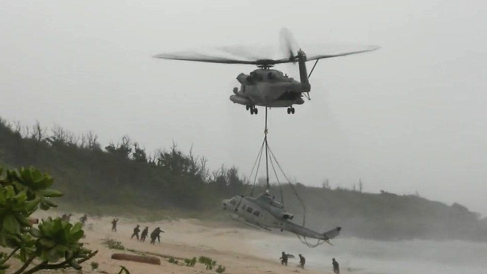 US chopper is airlifted by Marines off a beach in Okinawa, Japan