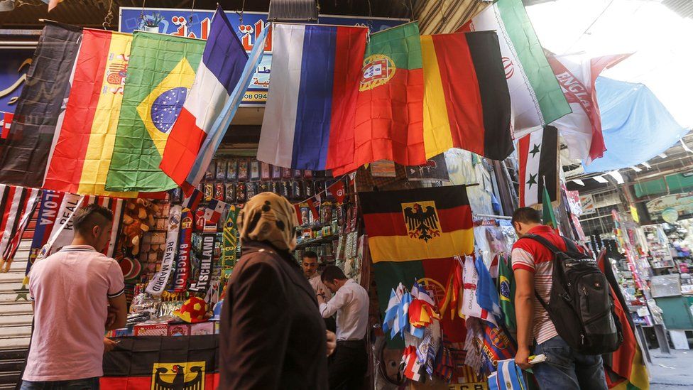 A shop in the old city of Damascus selling flags of the World Cup finals teams