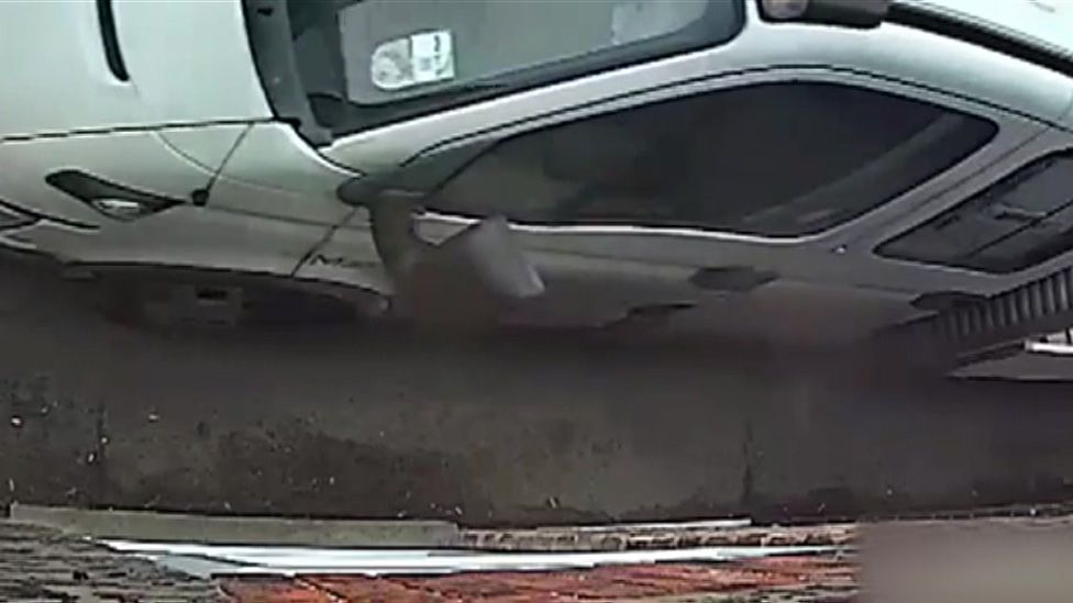 Van driving on pavement