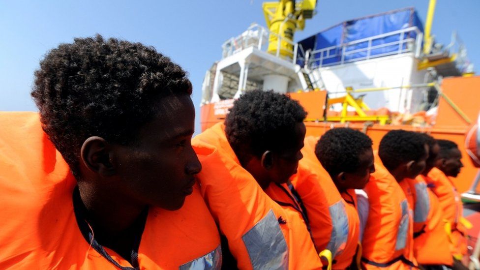 Migrants who were rescued by Aquarius in August, wearing orange life jackets