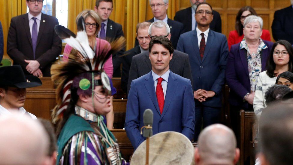 Canada's Prime Minister Justin Trudeau listens to a drummer after delivering a statement of exoneration to the Tsilhqot"in Nation and the descendants of six Tsilhqot"in Chiefs in the House of Commons on Parliament Hill in Ottawa, Ontario, Canada on 26 March 2018.