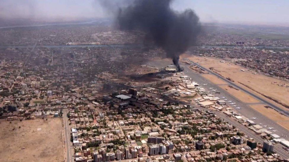 This image grab taken from AFPTV video footage on April 20, 2023, shows an aerial view of black smoke rising above the Khartoum International Airport amid ongoing battles between the forces of two rival generals