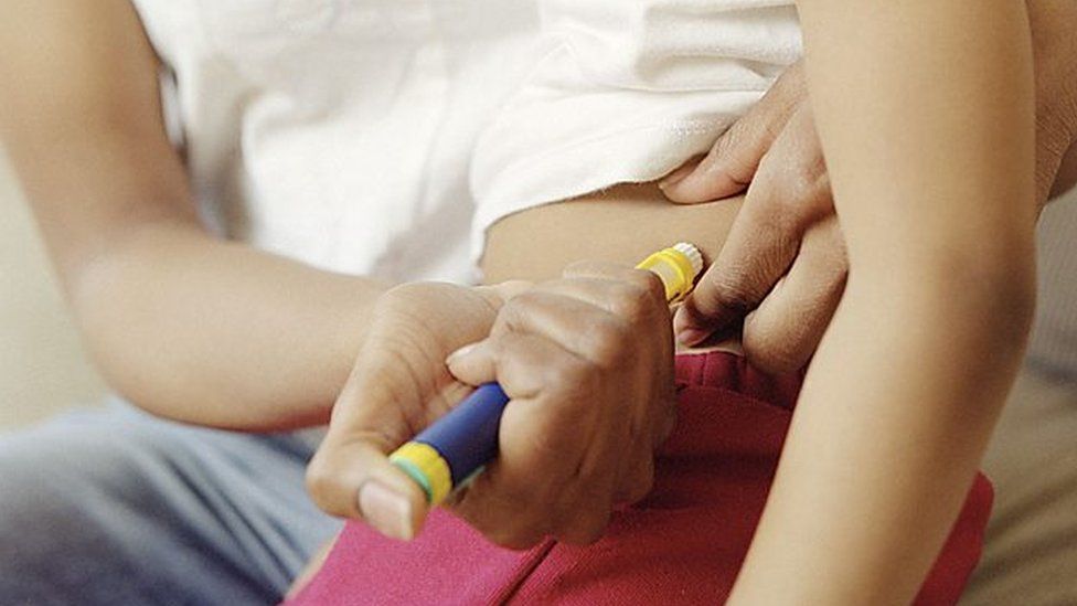 Insulin pen being administered