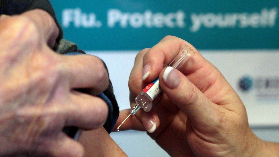 flu jab being administered