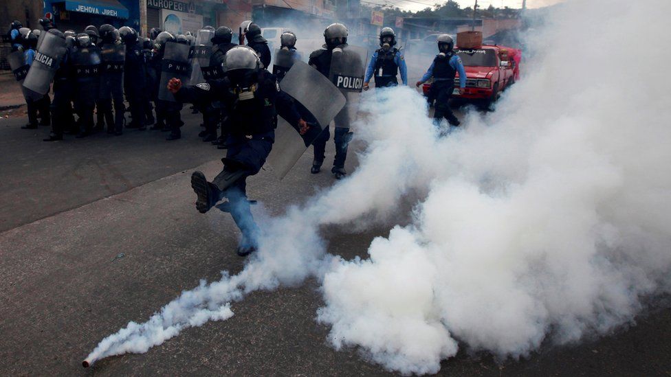 A riot policeman kicks a tear gas canister to demonstrators, during a protest against the re-election of Honduras" President Juan Orlando Hernandez in Tegucigalpa Honduras January 20, 2018.
