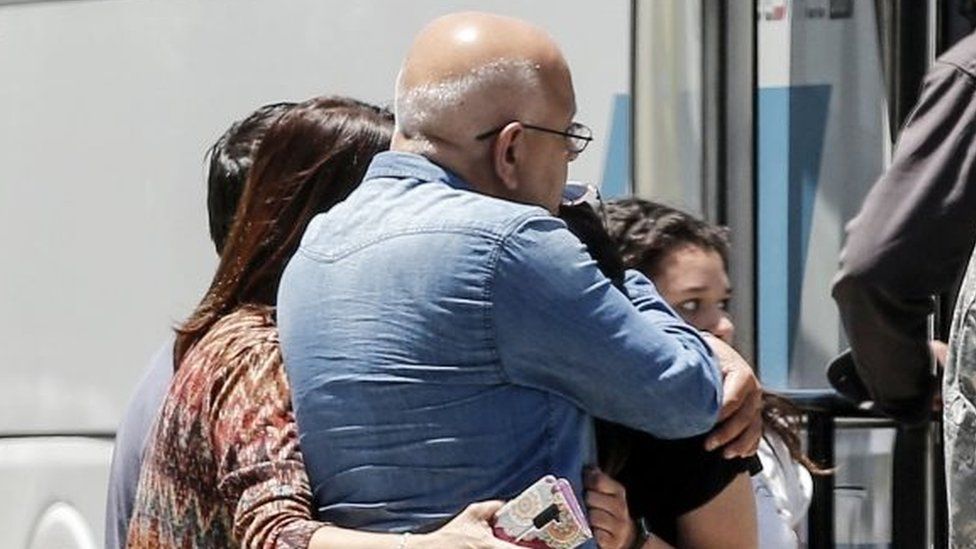 Relatives of people aboard the Chilean Air Force C-130 Hercules cargo plane that went missing embrace at the Cerrillos base in Santiago